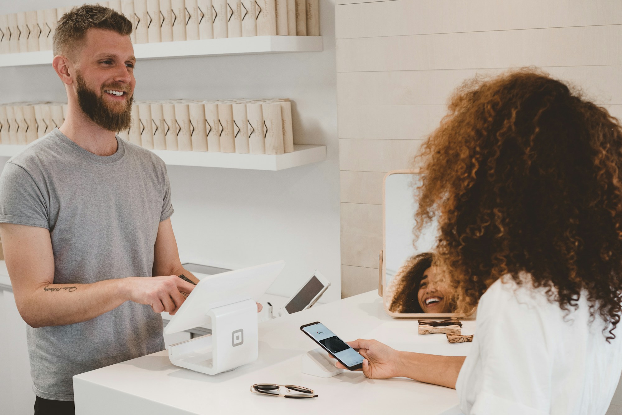 A shop owner helping a customer at the counter
