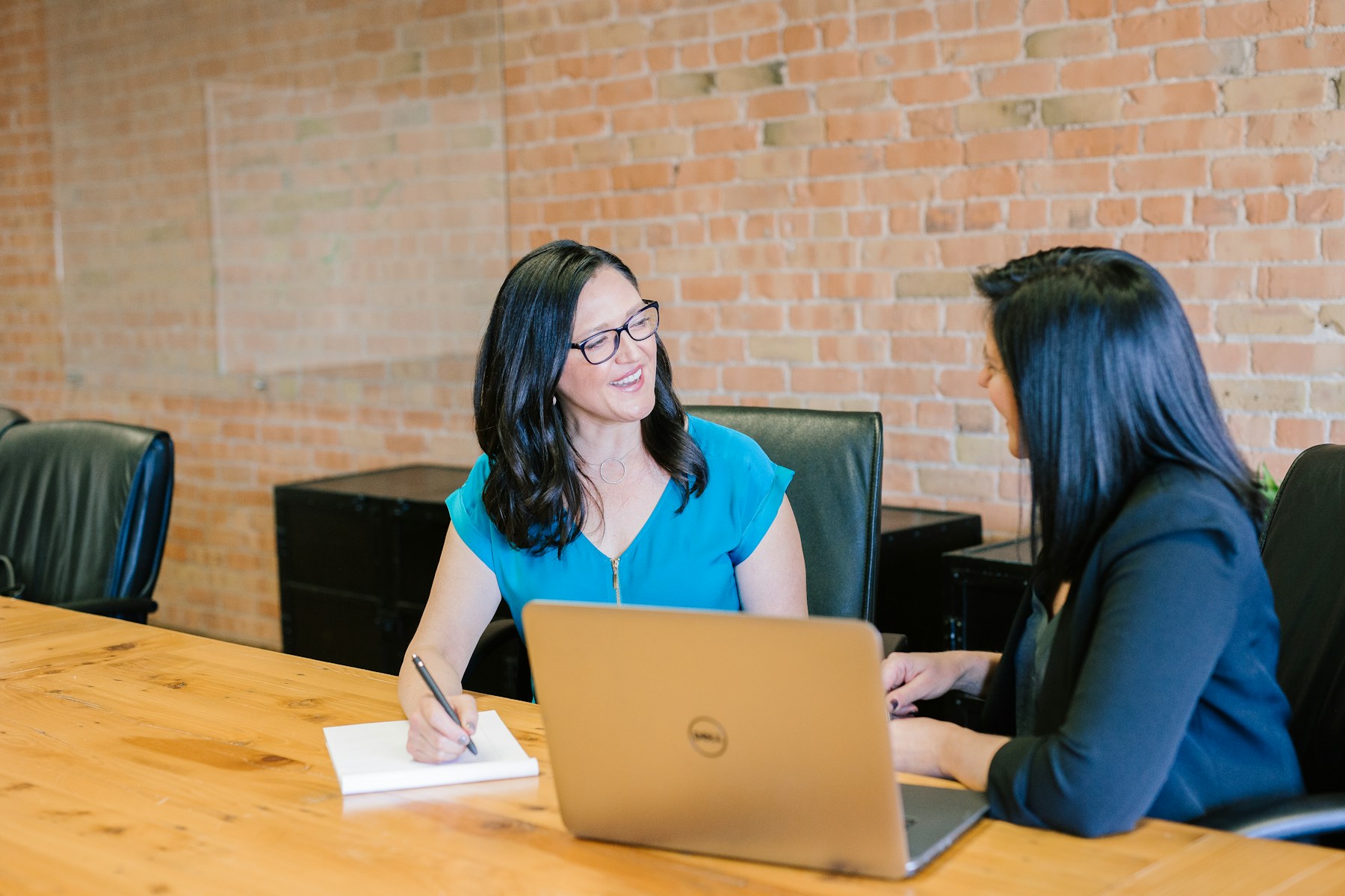 Two colleagues working together at a laptop